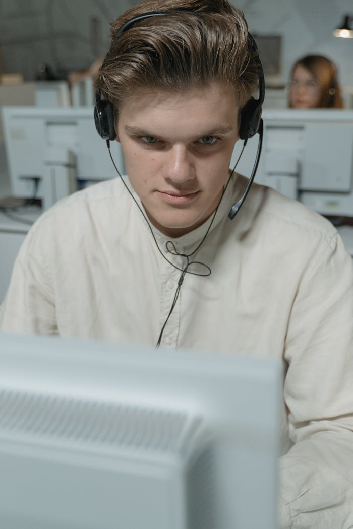 Focused call center employee providing professional customer support in an office.